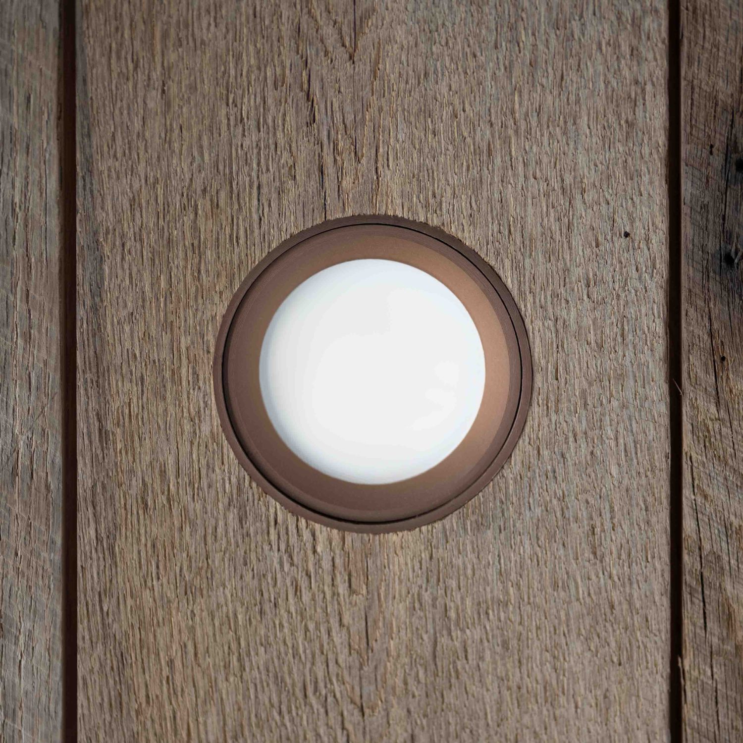 LumiSlim bronze wood ring flush in a wood plank ceiling